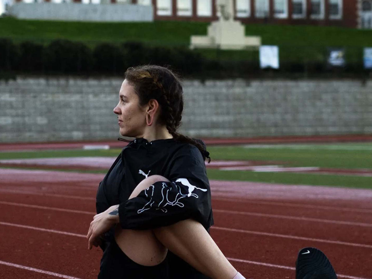 Photo of Meggyn stretching on a track by Jen Hofer