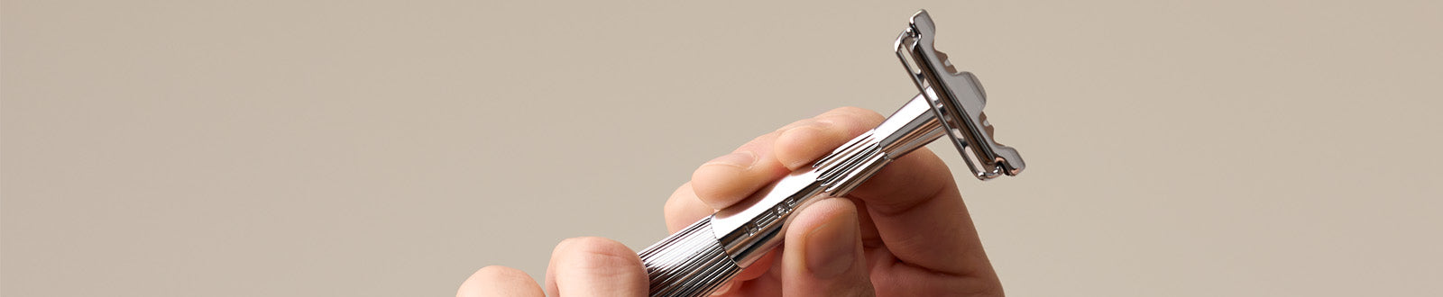 User holds up the single edge razor