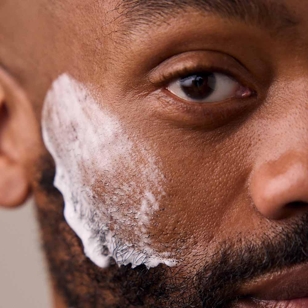 Closeup of a man's cheek with shave soap