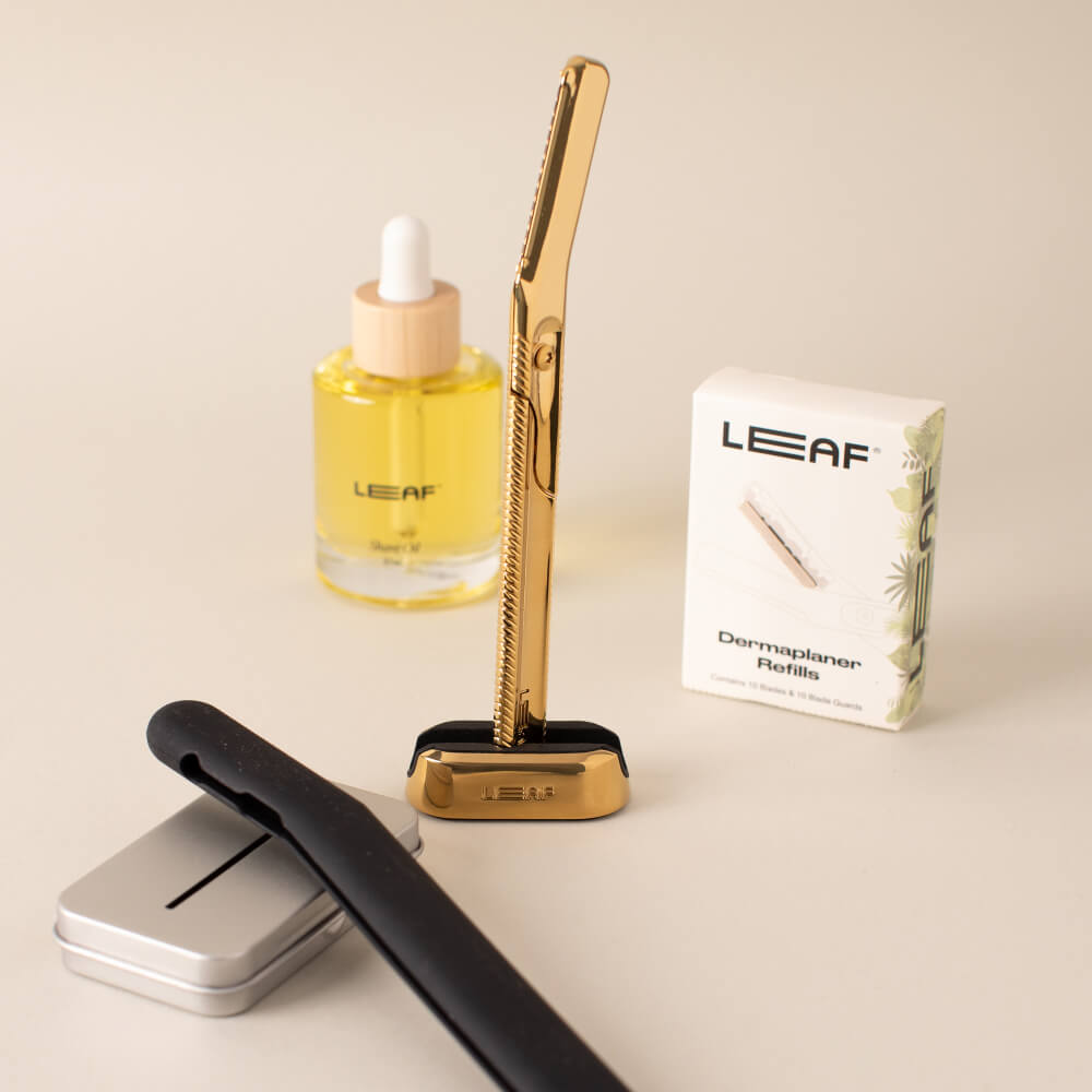 The gold dermaplaner super bundle with the dermaplaner, case, shave oil, blades, and recycling tin