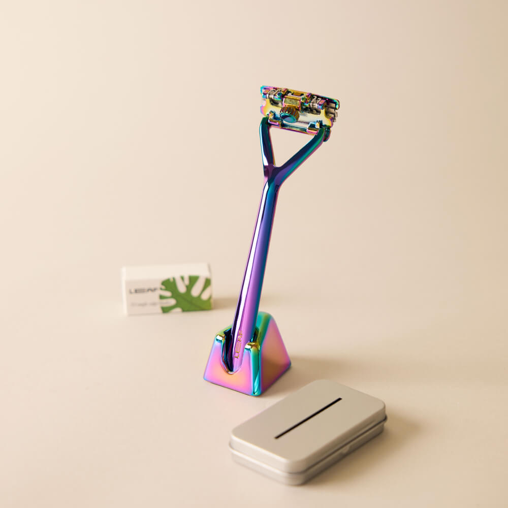 The prism Leaf razor kit with the razor, stand, package of blades, and recyclable tin 