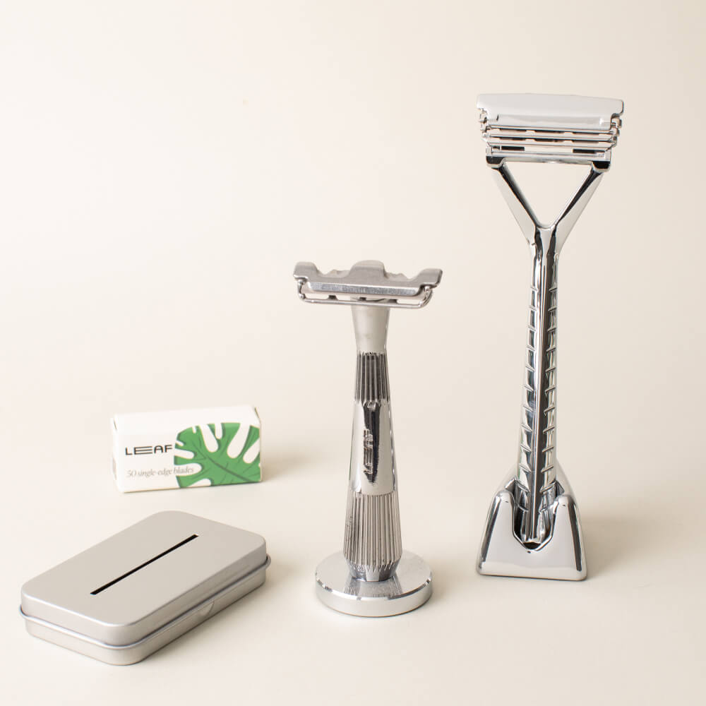 A chrome razor set kit with a leaf and single edge razors, blades, and recycling tin