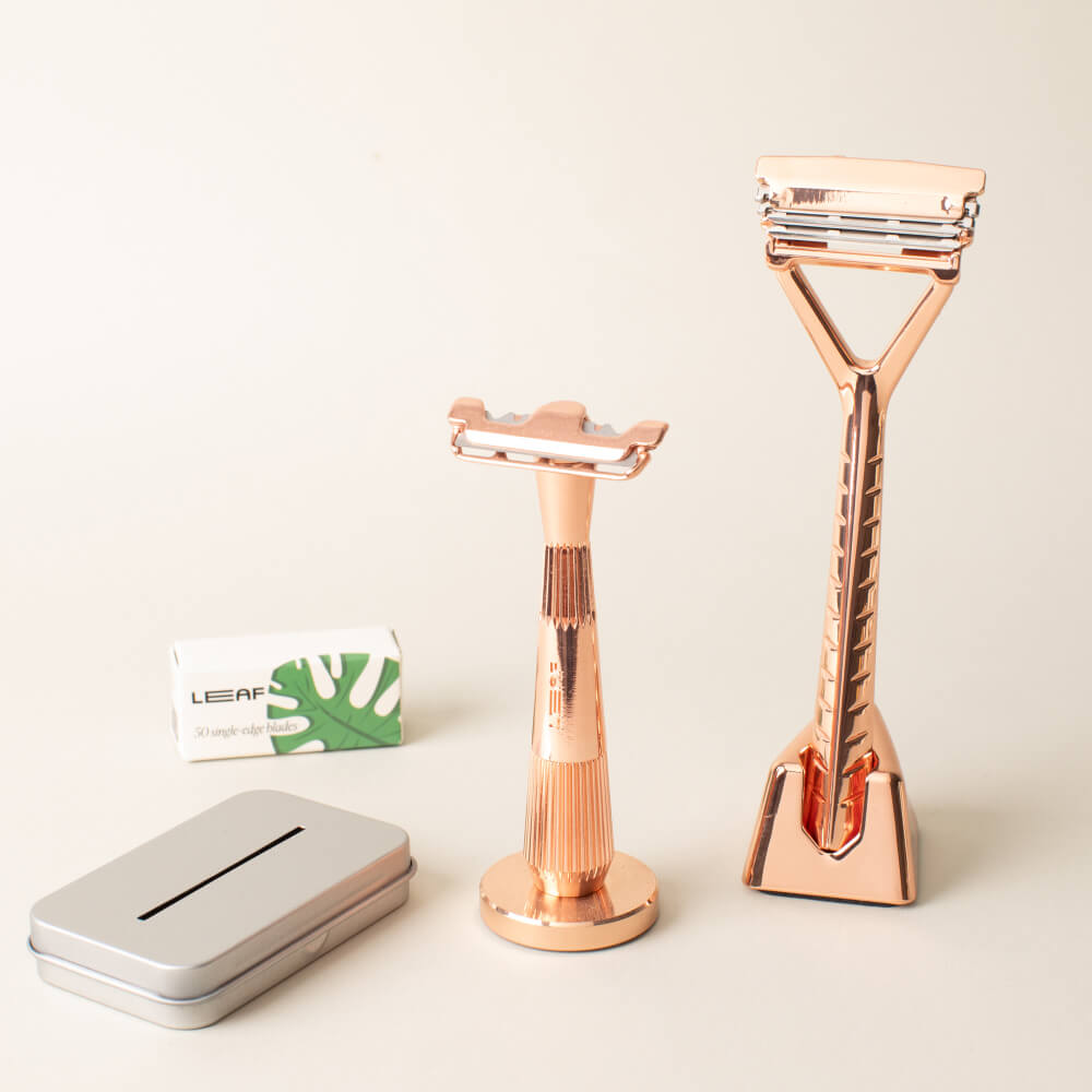 A rose gold razor set kit with a Leaf and single edge razors, blades, and recycling tin