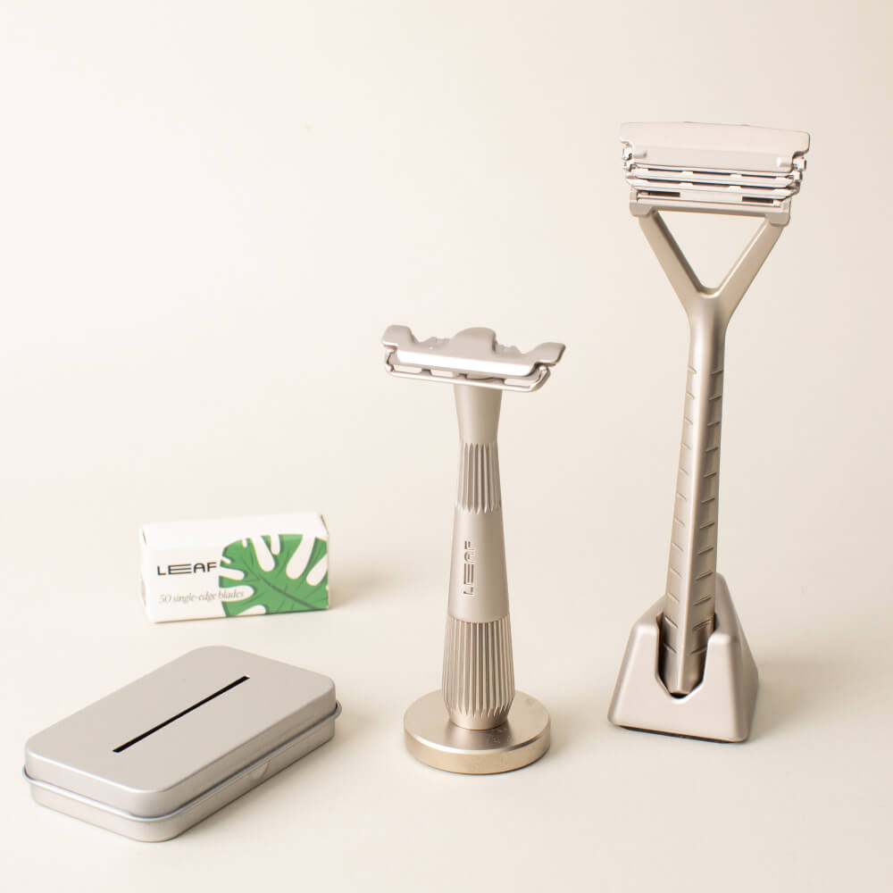 A silver razor set kit with a Leaf and single edge razors, blades, and recycling tin