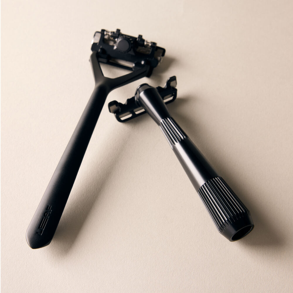 Leaf and single edge razor displayed side by side in black