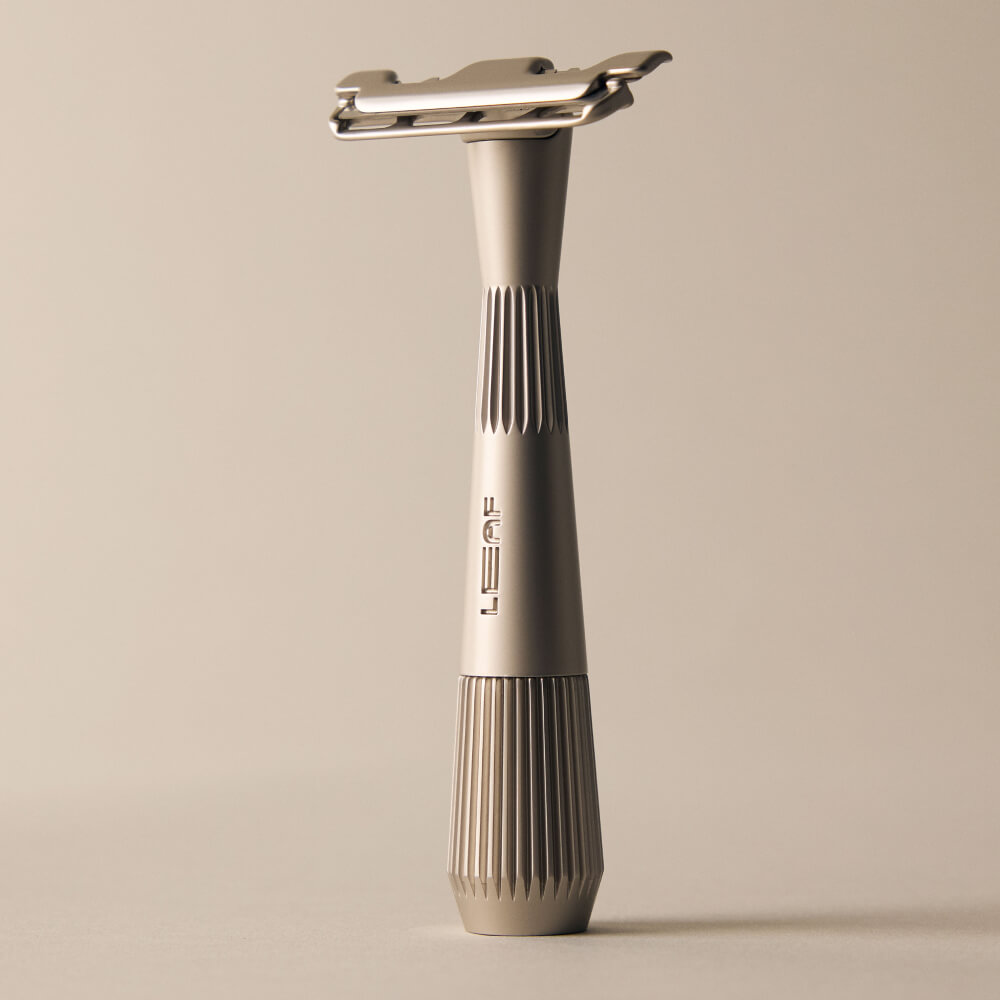 Silver single edge razor standing by itself