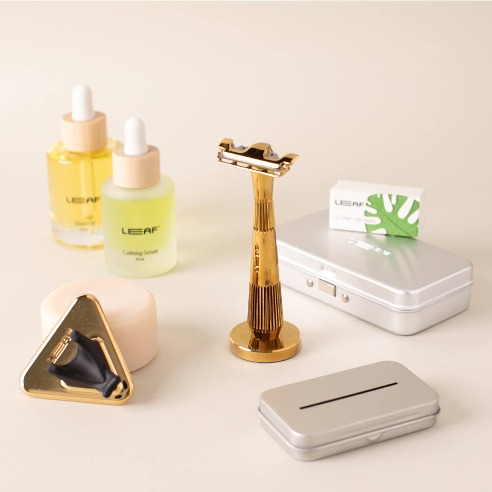 The gold single edge everything bundle with the single edge razor, stand, case, recycling tin, shave oil, calming serum, soap bar, and shower holder 